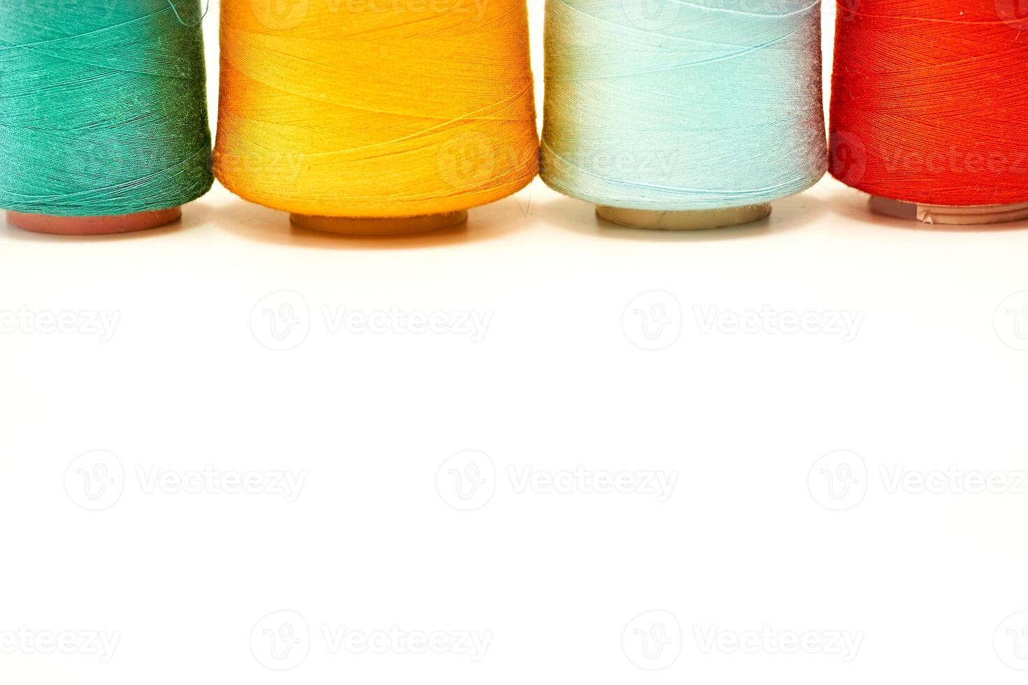 Four colored spools of thread.Tailoring supplies photo