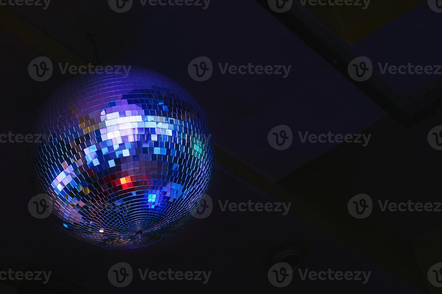 Night dance club. Shiny disco ball, shining colored ceiling photo