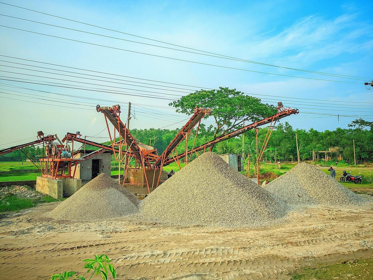a large pile of gravel sitting in front of a power line photo