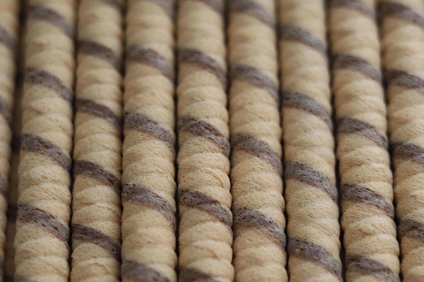 Brown and beige twisted rope rolls lined up in a neat arrangement on a flat surface in a well-lit space photo