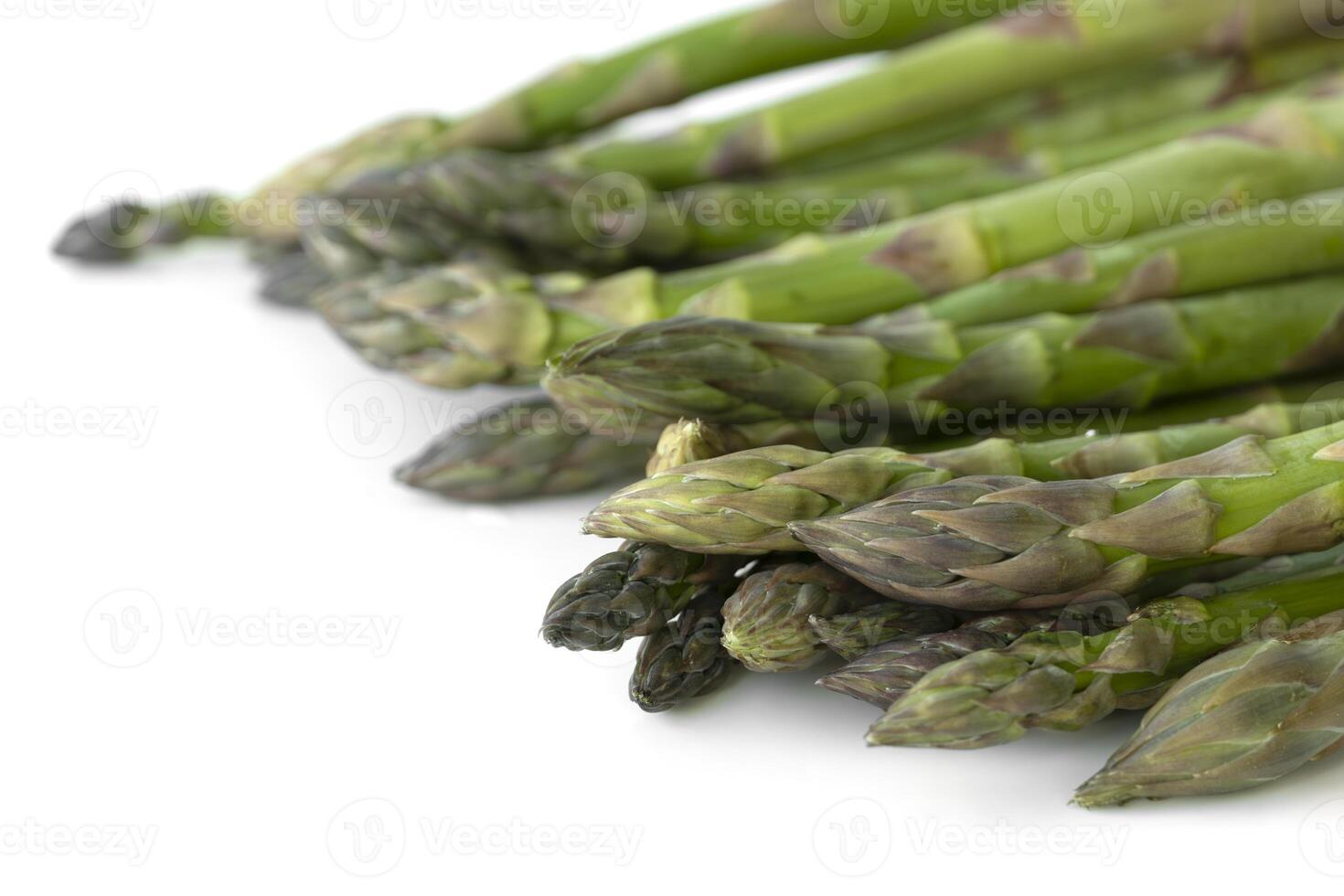 Fresh asparagus isolated on white background, healthy cooking, vegan meals, salads, and seasonal spring dishes. High in fiber and nutrients. photo