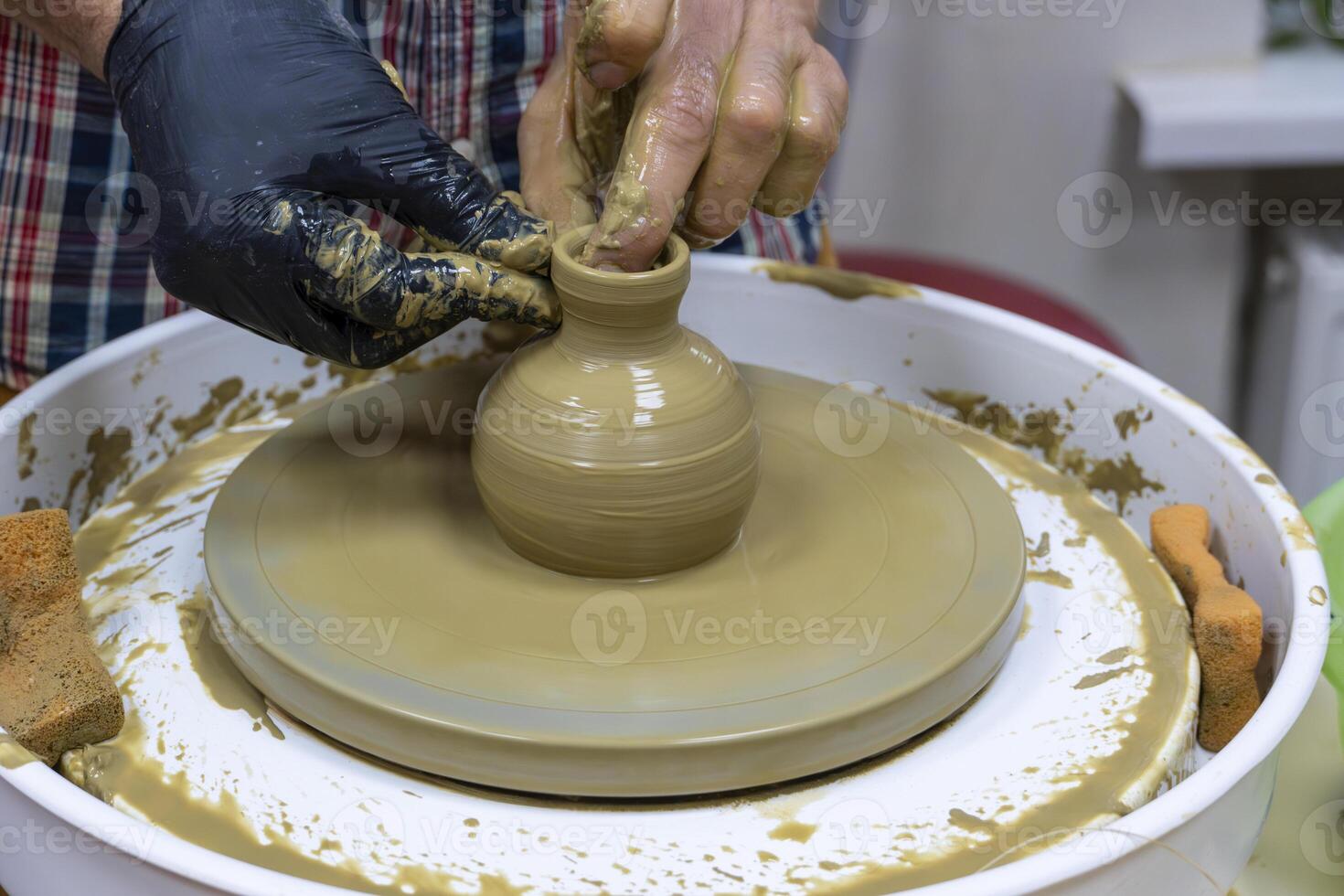 Wheel Throwing in Action Creating a Ceramic Bowl in Pottery Class photo