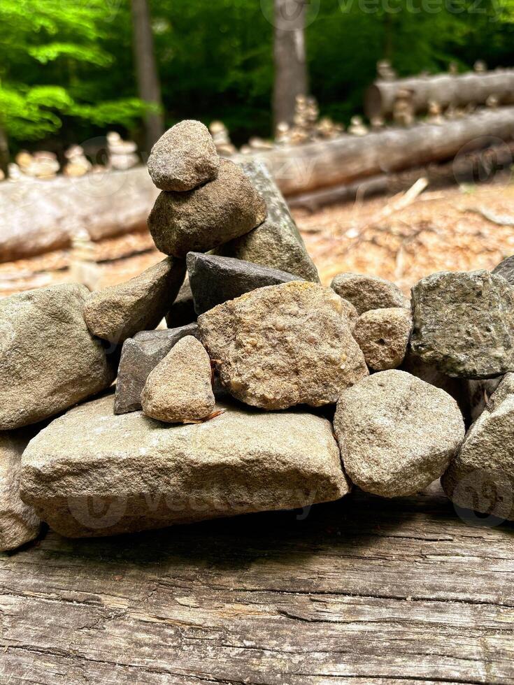 Zen stone pyramids on a rural road in a mountain forest. photo