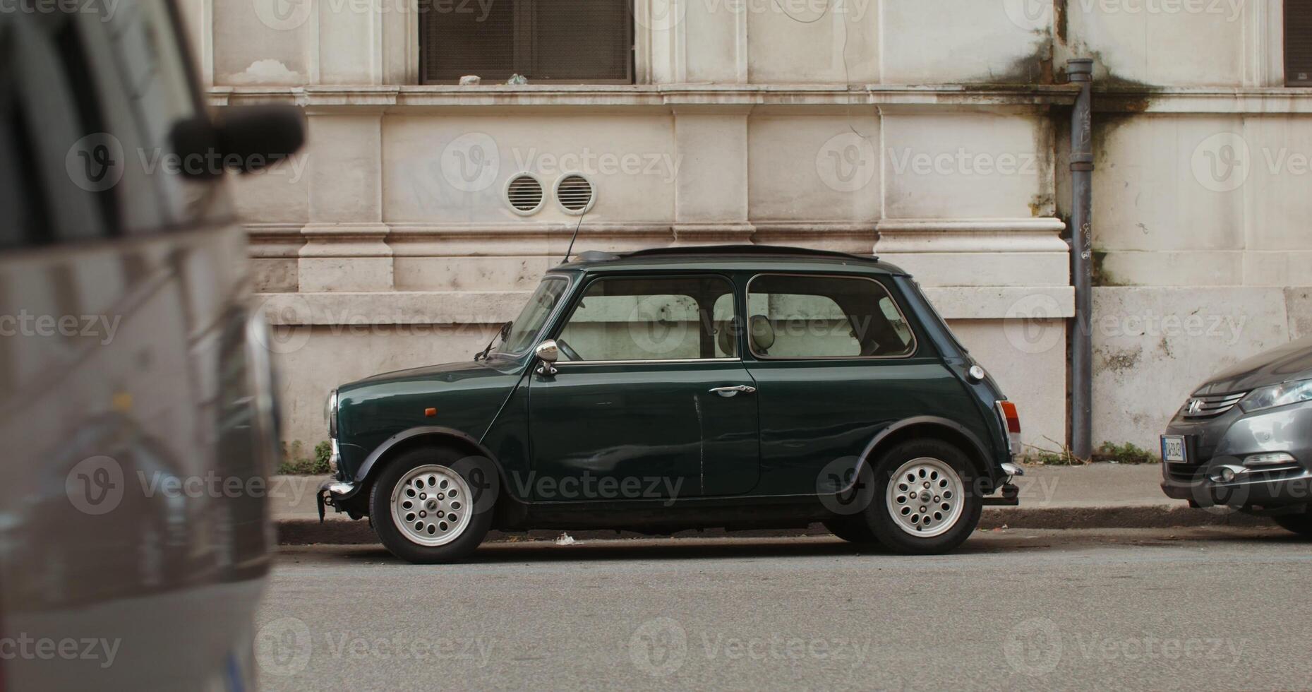 Vintage retro car parked on narrow busy street of a modern European city. in 4k, red komodo photo