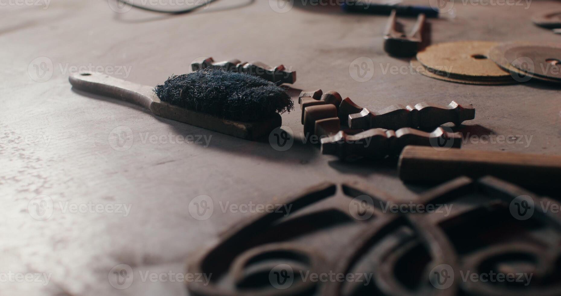 Forged metal products and working tools lie on the table of a blacksmith working on a new project. Close up of the master's desktop, no face, unrecognizable person. in 4k, red komodo photo