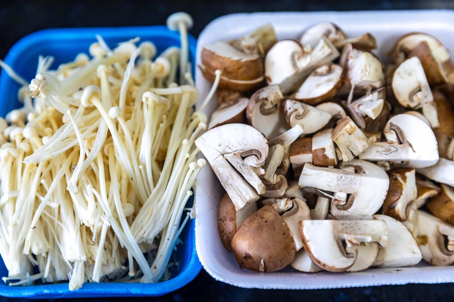 known as Enokitake, the Enoki mushroom Flammulina velutipes, is a variety widely used in oriental cuisine sliced photo