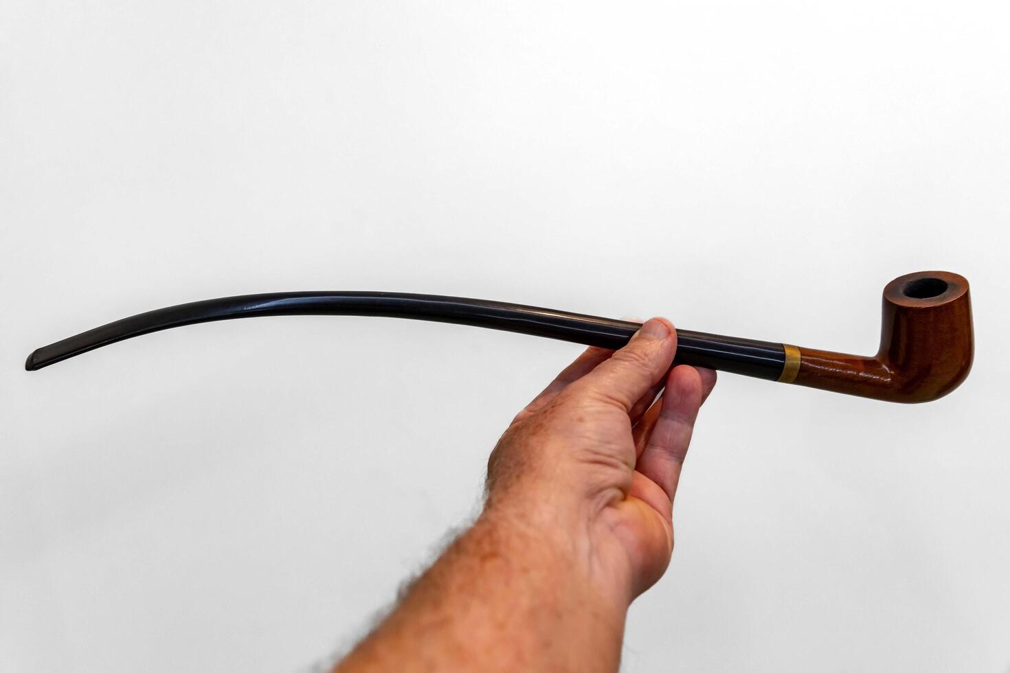 Hand holding luxurious pipe in selective focus and smooth background 6 photo