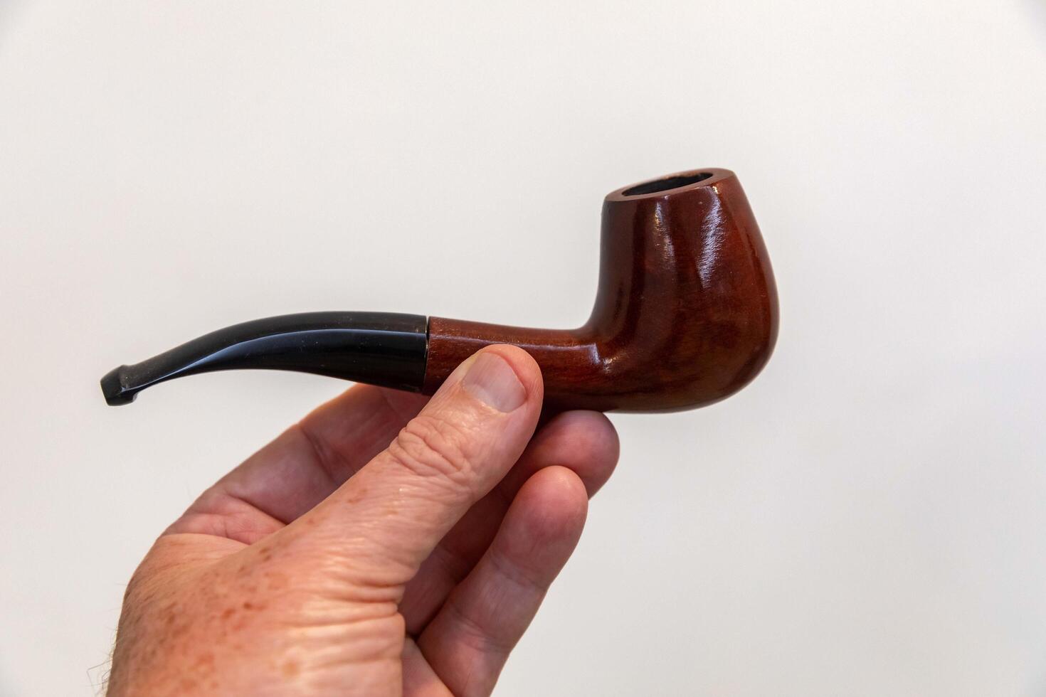 Hand holding luxurious pipe in selective focus and smooth background ZYZ photo