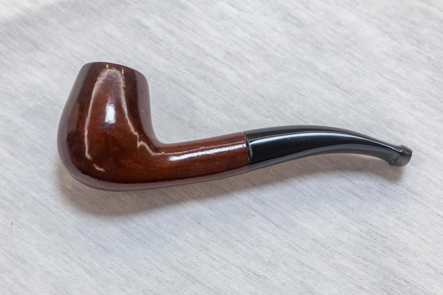 Hand holding luxurious pipe in selective focus and smooth background gls photo