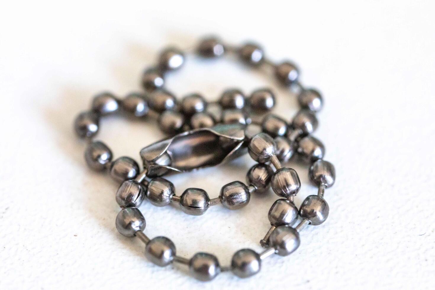 Small metal chain with balls and ingenious clasp macro photo