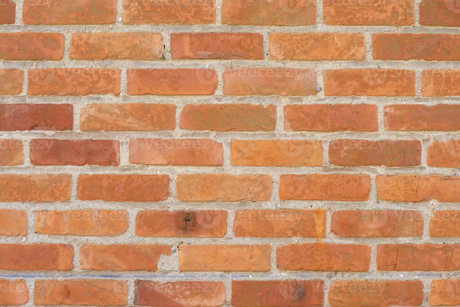 Brick wall in different shades of red and orange, Spoon masonry in half brick, attractive textured background in rustic style, aged surface, photo