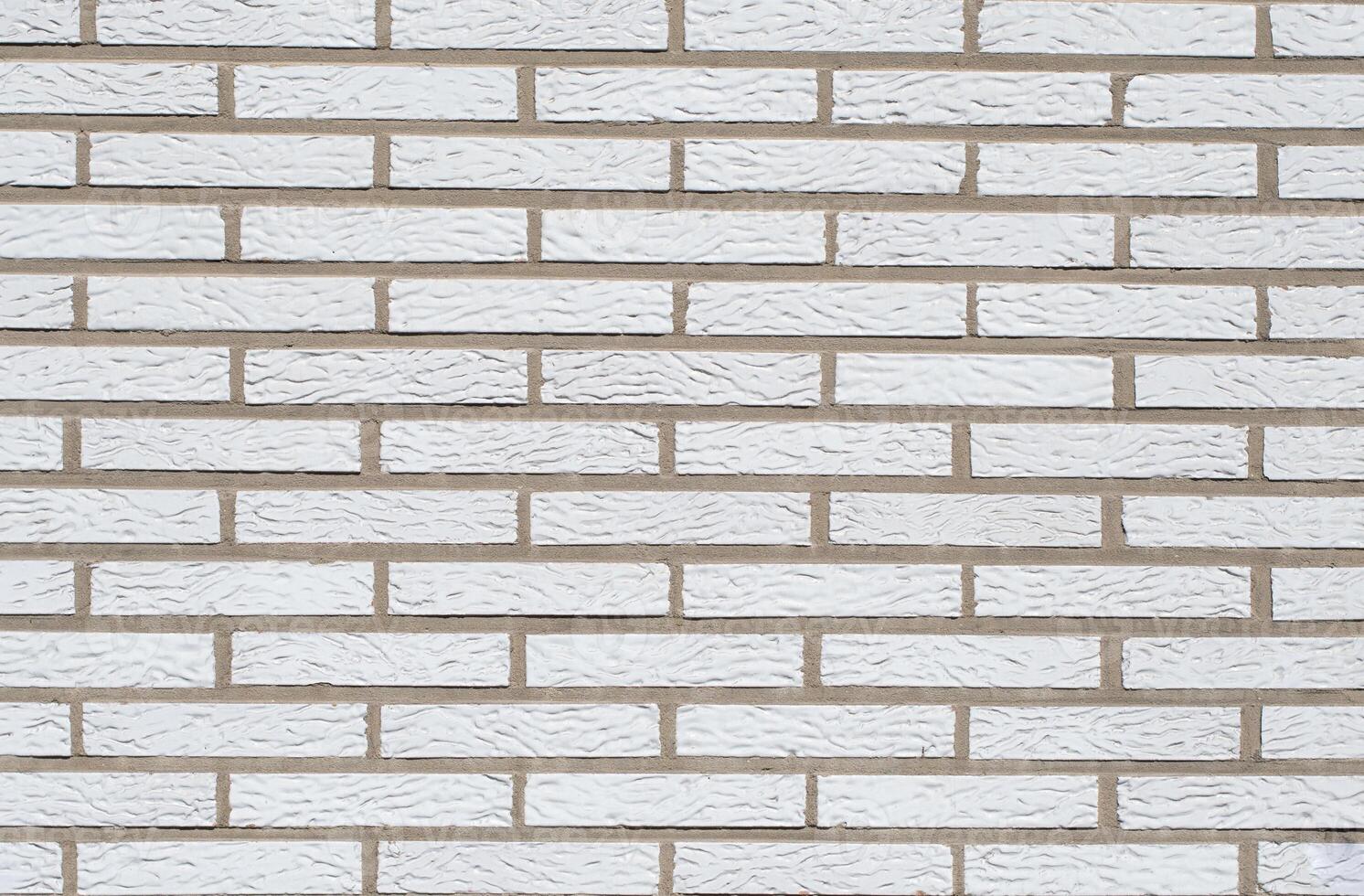 White brick background, textured surface showing spoon masonry, ideal for various design and architectural projects, photo