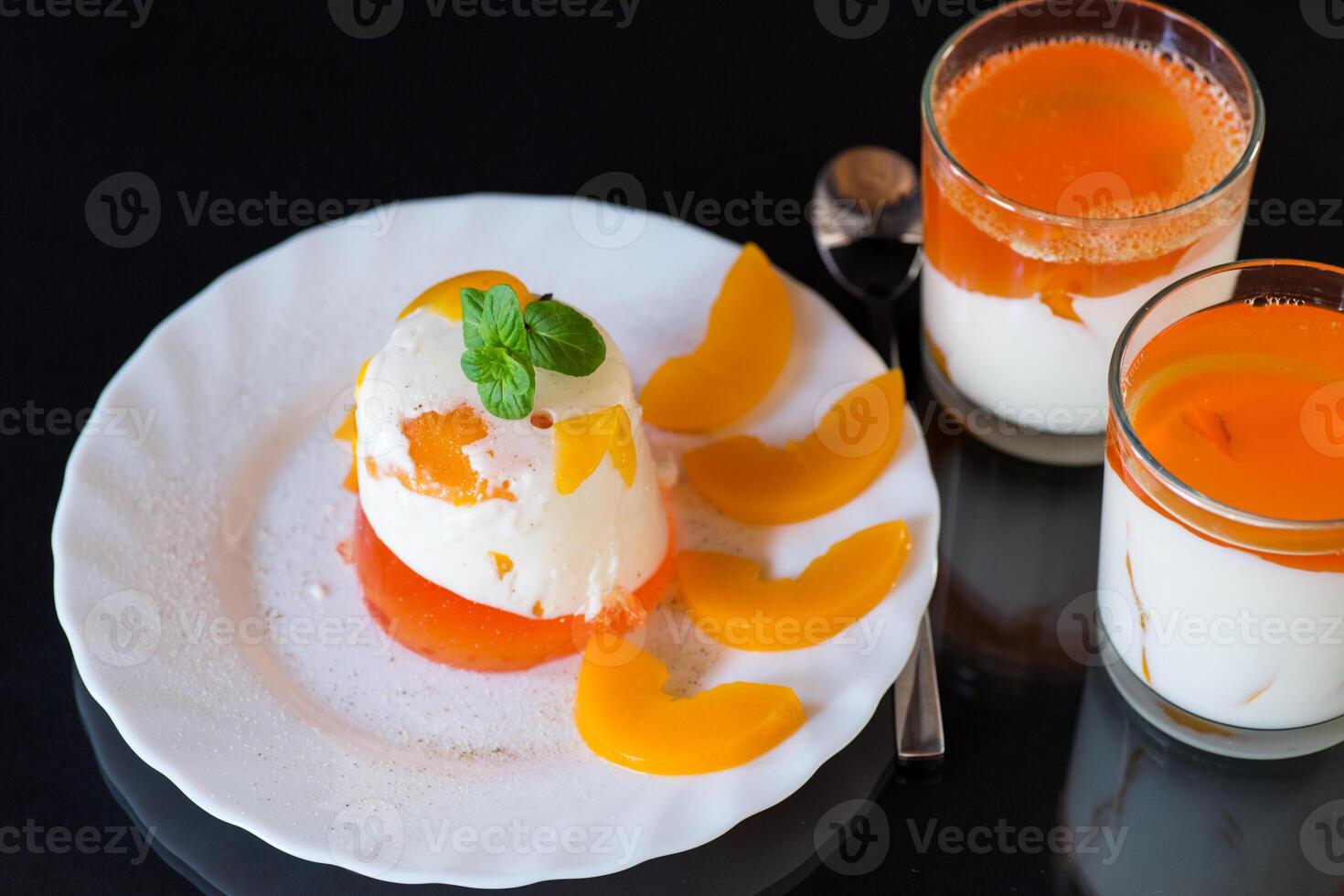 Light milk dessert with bright layers of jelly. photo