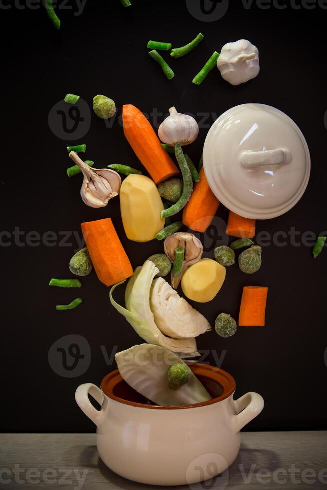 Vegetables in motion before cooking in soup . photo