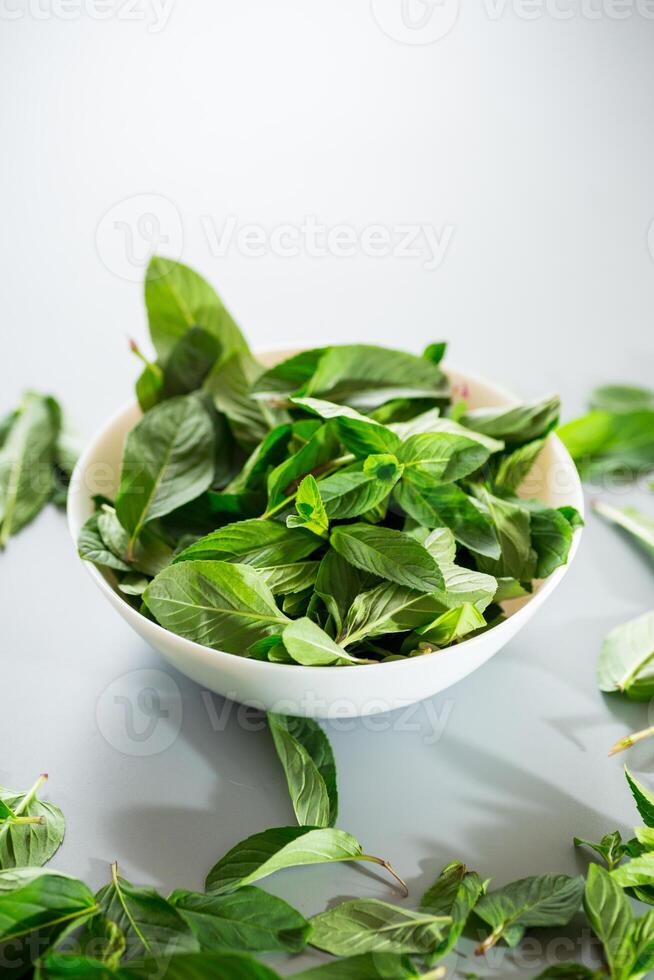 Bunch of fresh mint in plate on gray background from above photo