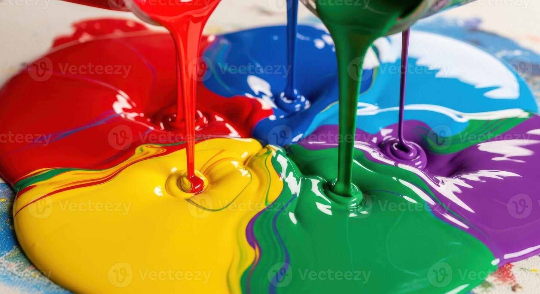 Vibrant primary and secondary colors of paint pouring and mixing together in a fluid abstract. photo