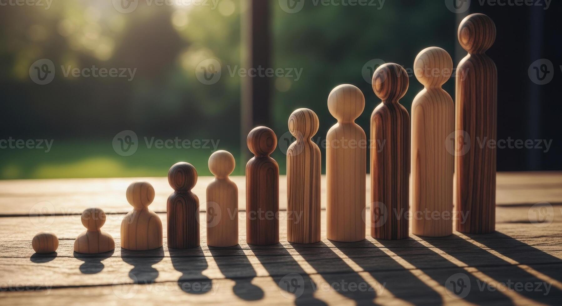 Wooden peg dolls arranged in ascending size, symbolizing growth, development, and life stages. photo