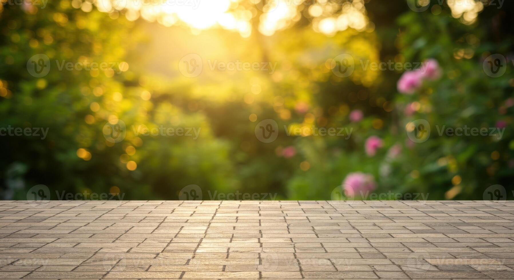 Empty stone patio with blurred green garden background and warm sunlit bokeh effect. photo