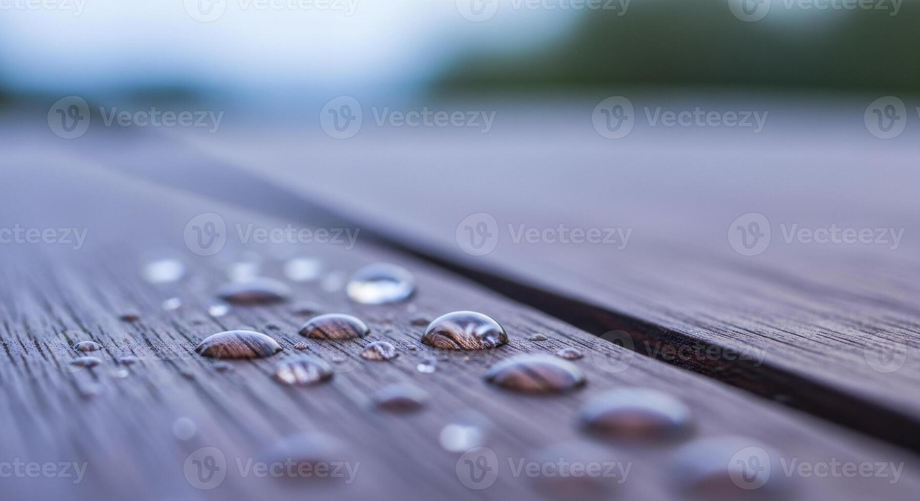 Glistening dew drops on dark weathered mahogany wood surface in a detailed macro shot. photo