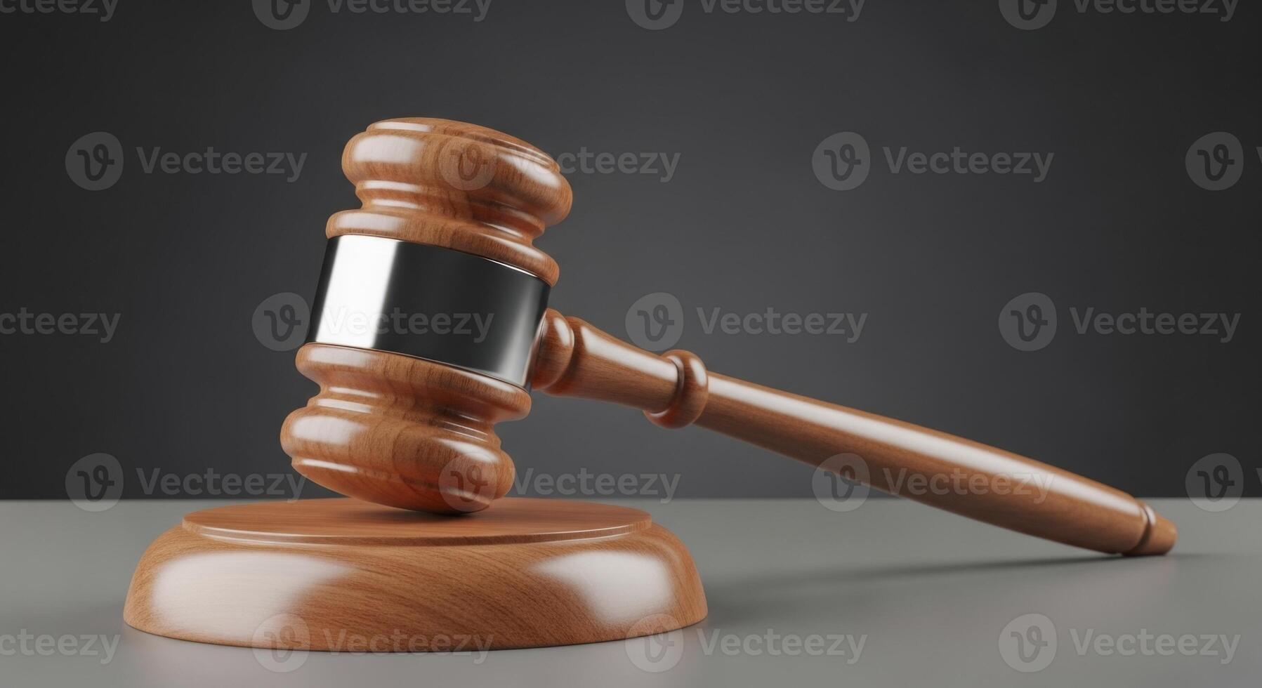 Wooden judge gavel with silver band on a sound block, symbolizing justice and law. photo