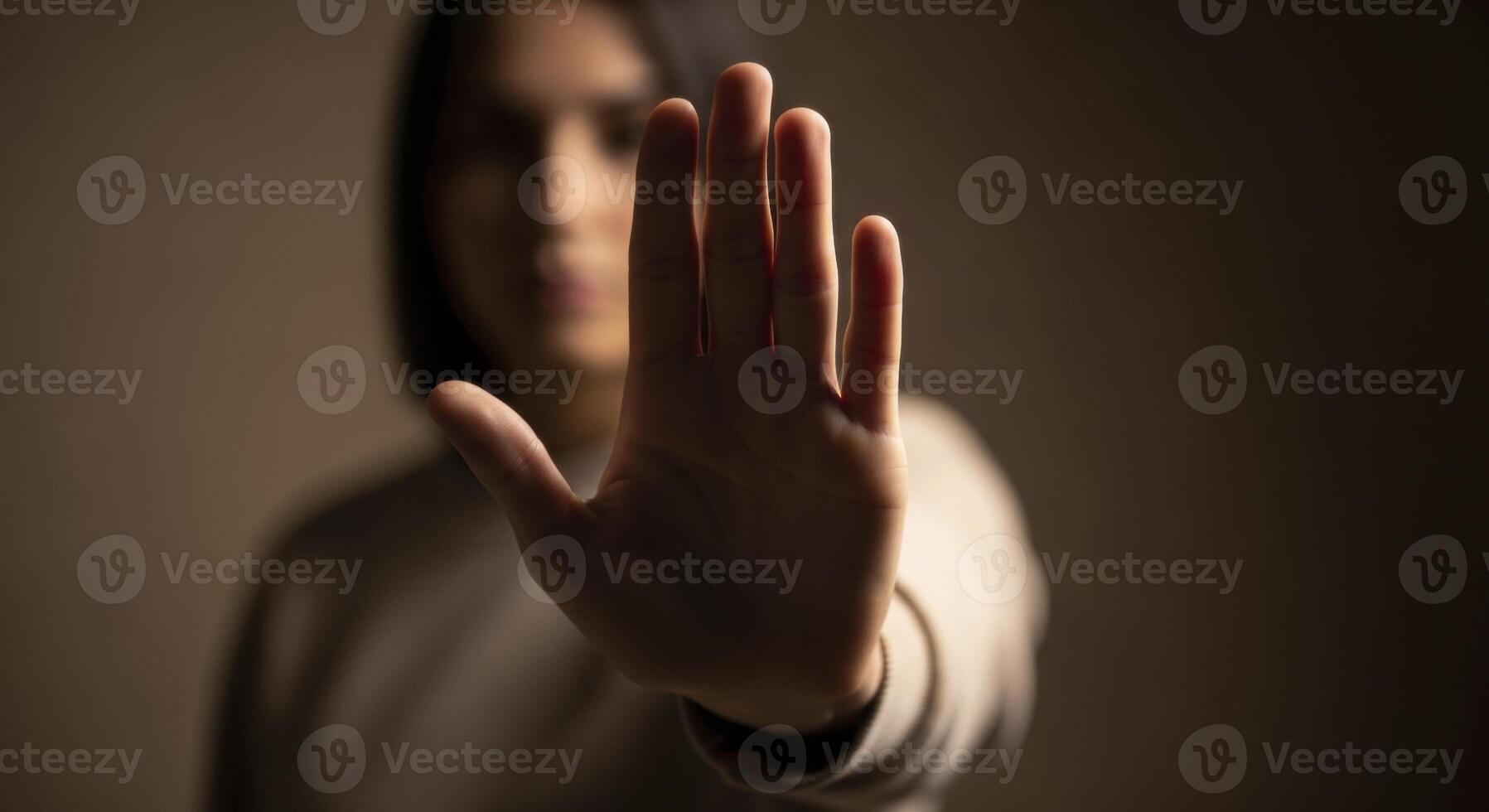 Person hand held up with palm facing forward, signaling stop, refusal, or boundary. photo