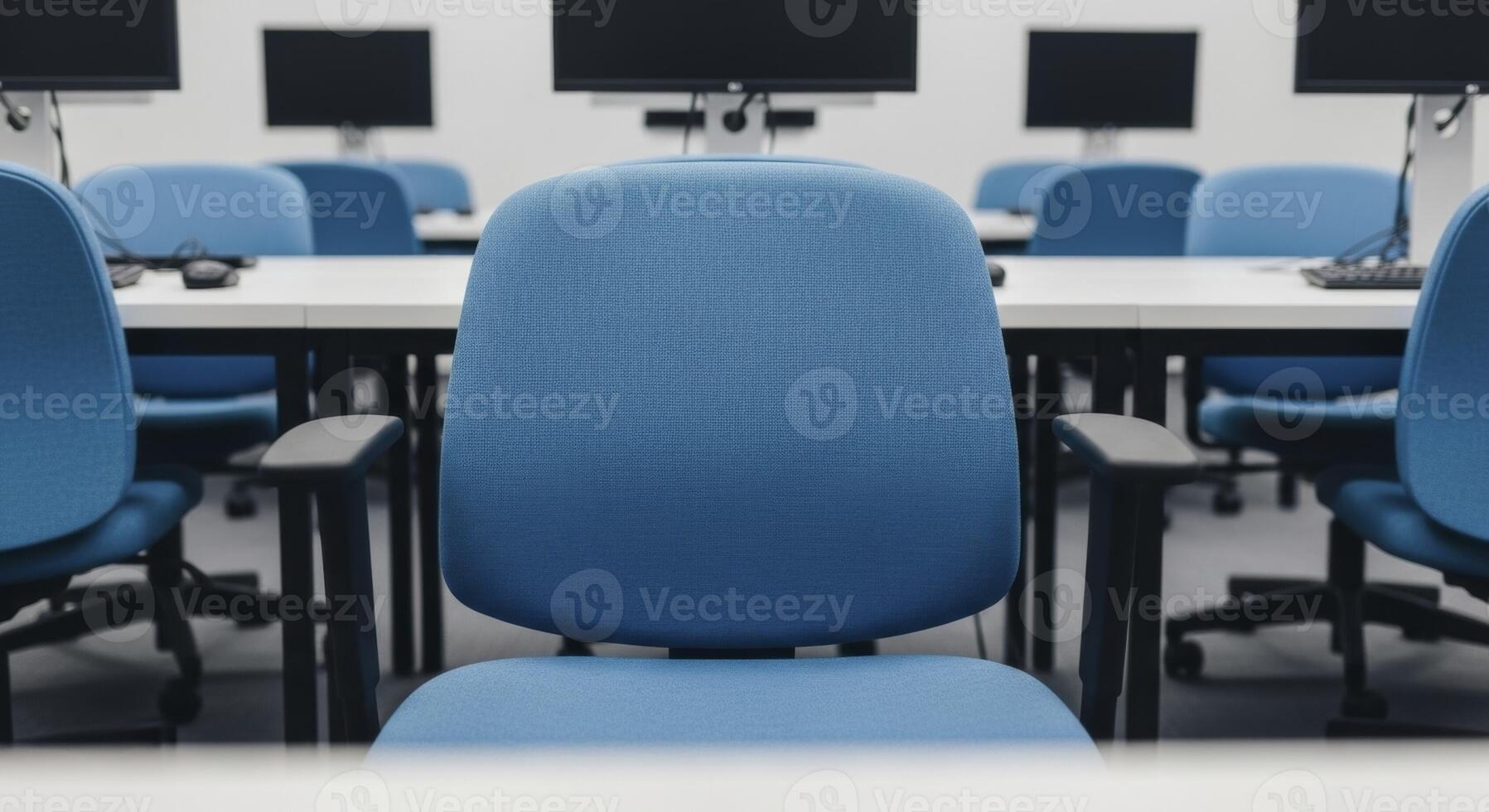 Empty modern computer lab with blue chairs and white desks for education and training photo