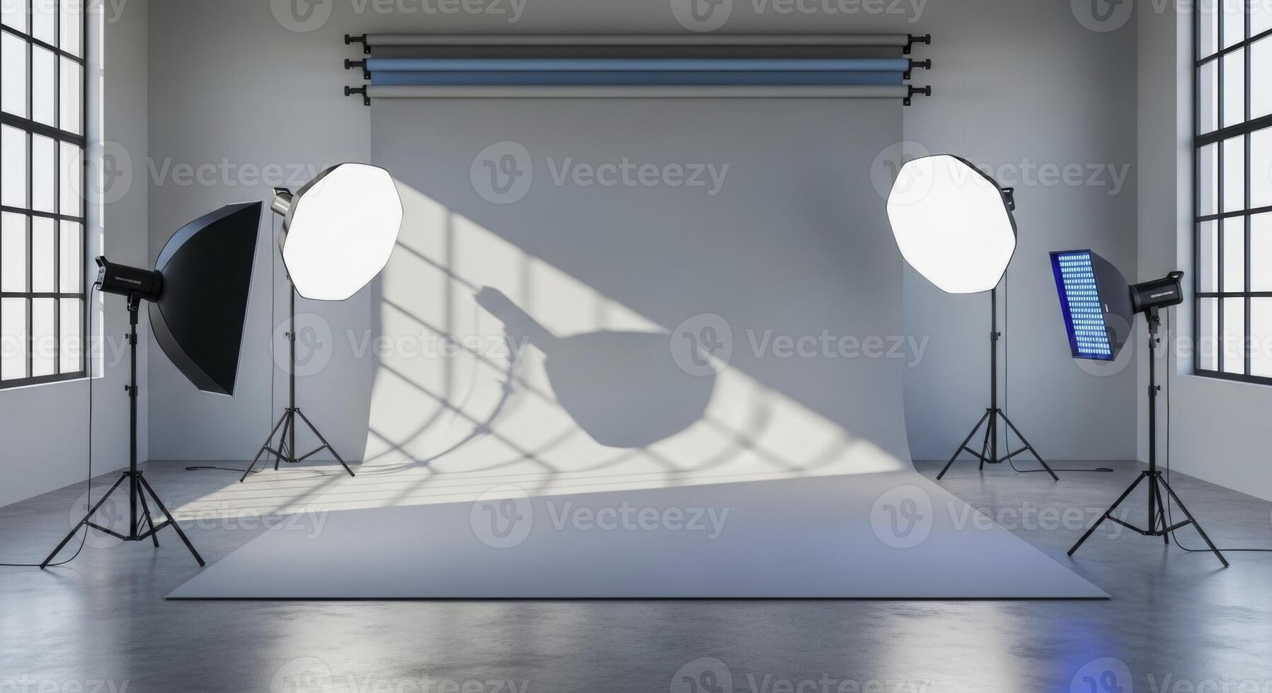 Empty professional photography studio with seamless grey backdrop and lighting equipment photo