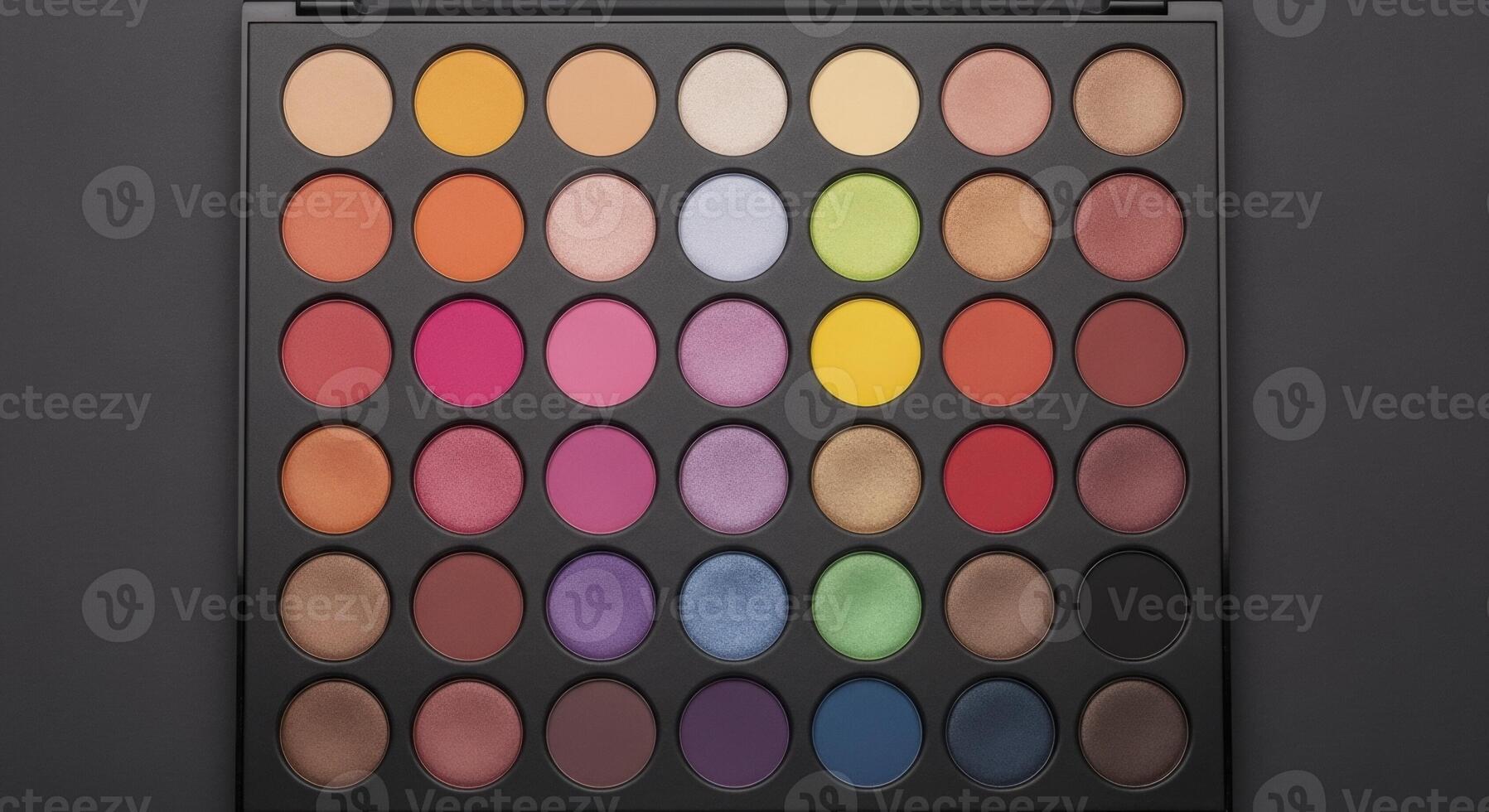 Professional top down view of a large makeup palette with many colorful eyeshadow pans photo