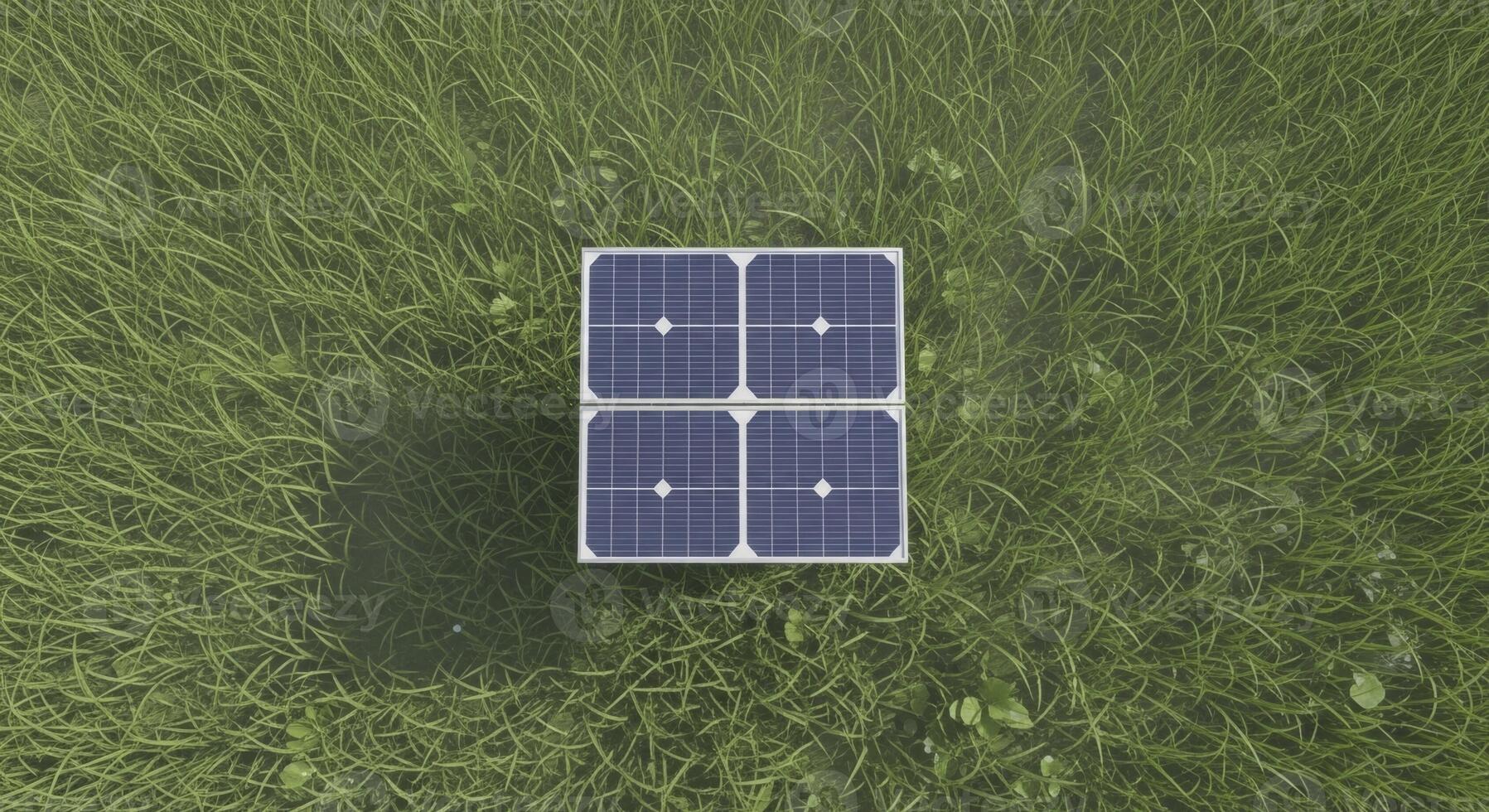 Overhead view of a small square solar panel array on green grass for renewable energy photo
