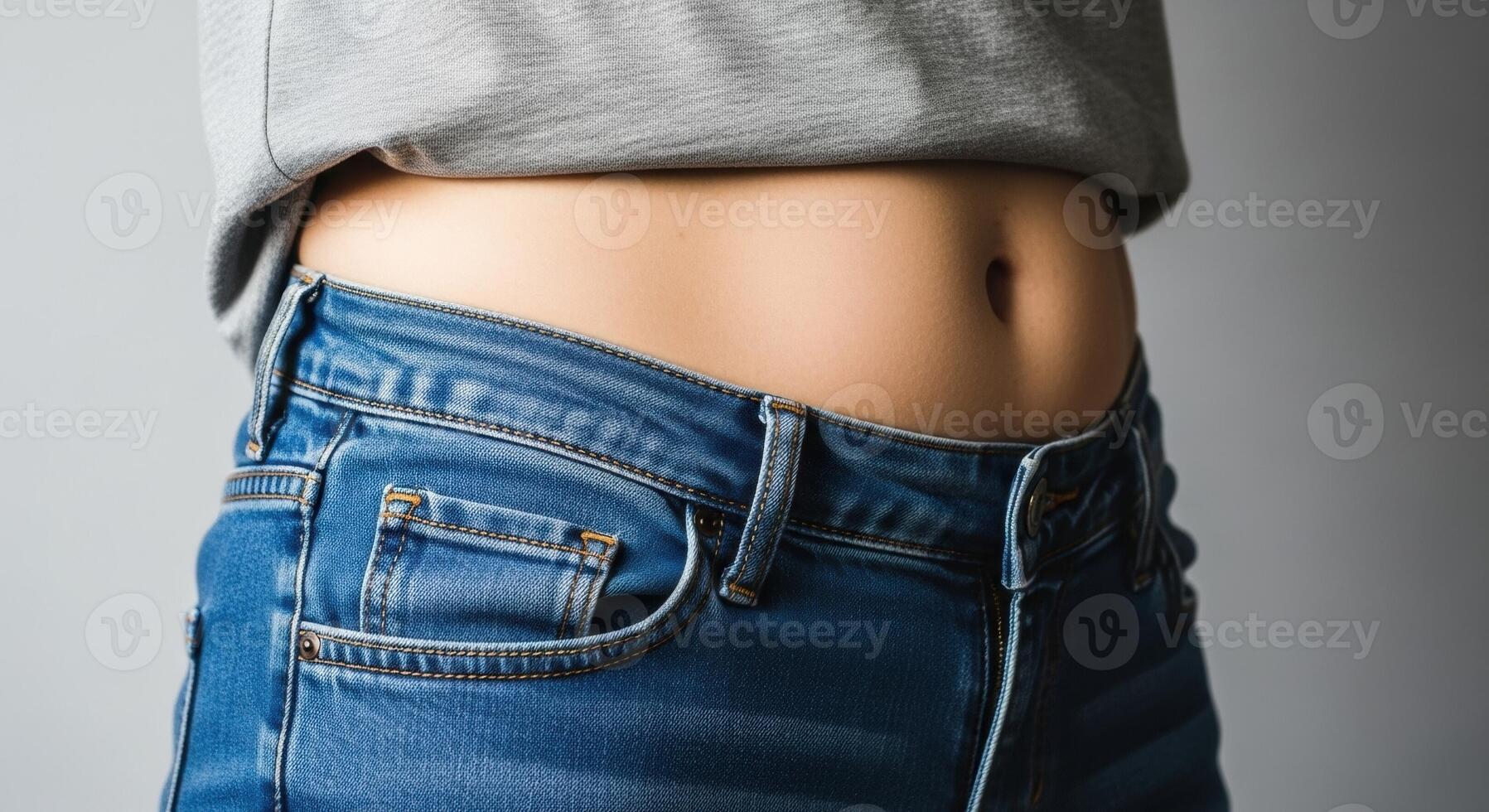 Woman Midsection with Tight Blue Jeans and a Grey T Shirt photo