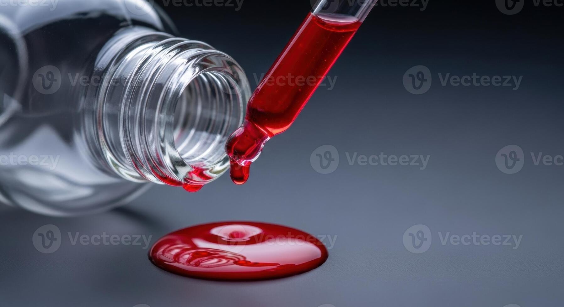 Red liquid dripping from a glass dropper into a bottle with a spill on a dark surface photo