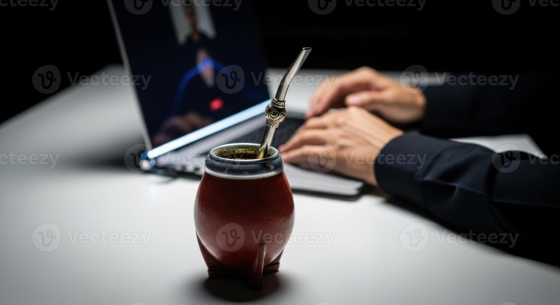 Mate Gourd and Laptop on Desk During Call for Remote Work and Productivity photo