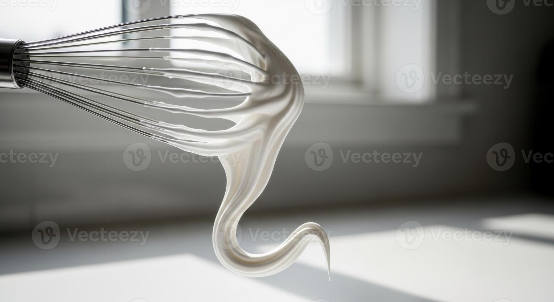 Metal Whisk with Dripping White Creamy Meringue or Whipped Cream photo