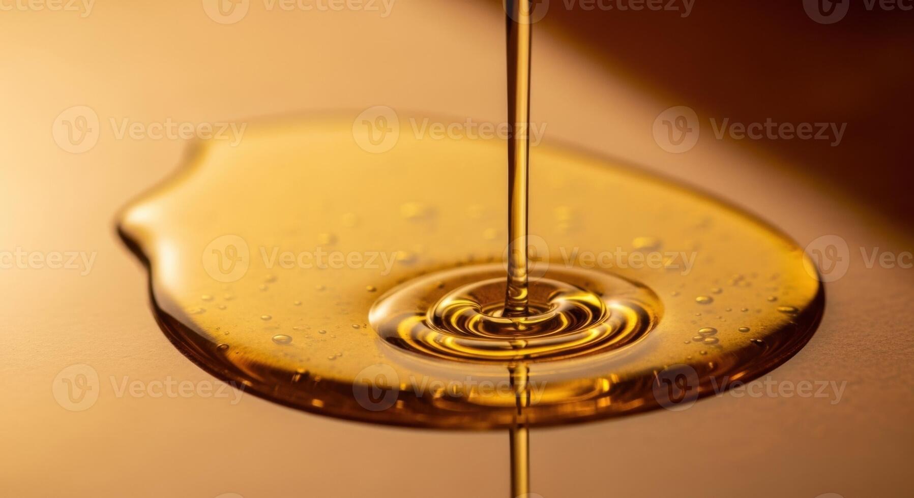 Golden liquid pouring and pooling on a reflective surface with rich texture and ripples photo