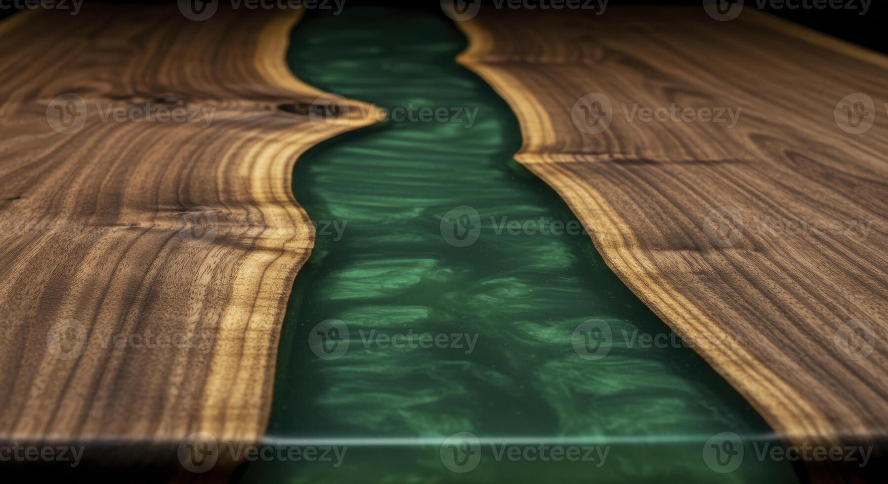 Emerald green resin river flowing through a live edge walnut wood tabletop with polished surface photo