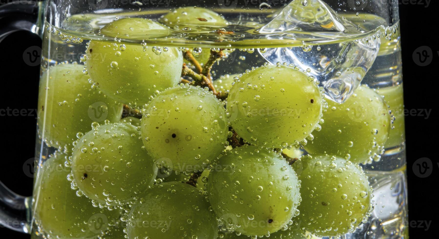 Vibrant Green Grapes Submerged in Sparkling Water with Ice in a Glass Pitcher photo