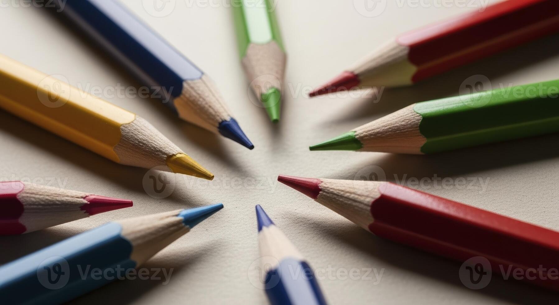 Brightly colored pencils arranged in a circle with sharpened tips pointing inwards photo
