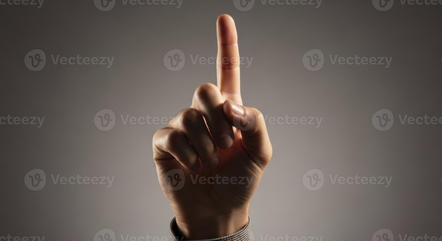 Human hand with index finger pointing upwards indicating direction or number one photo