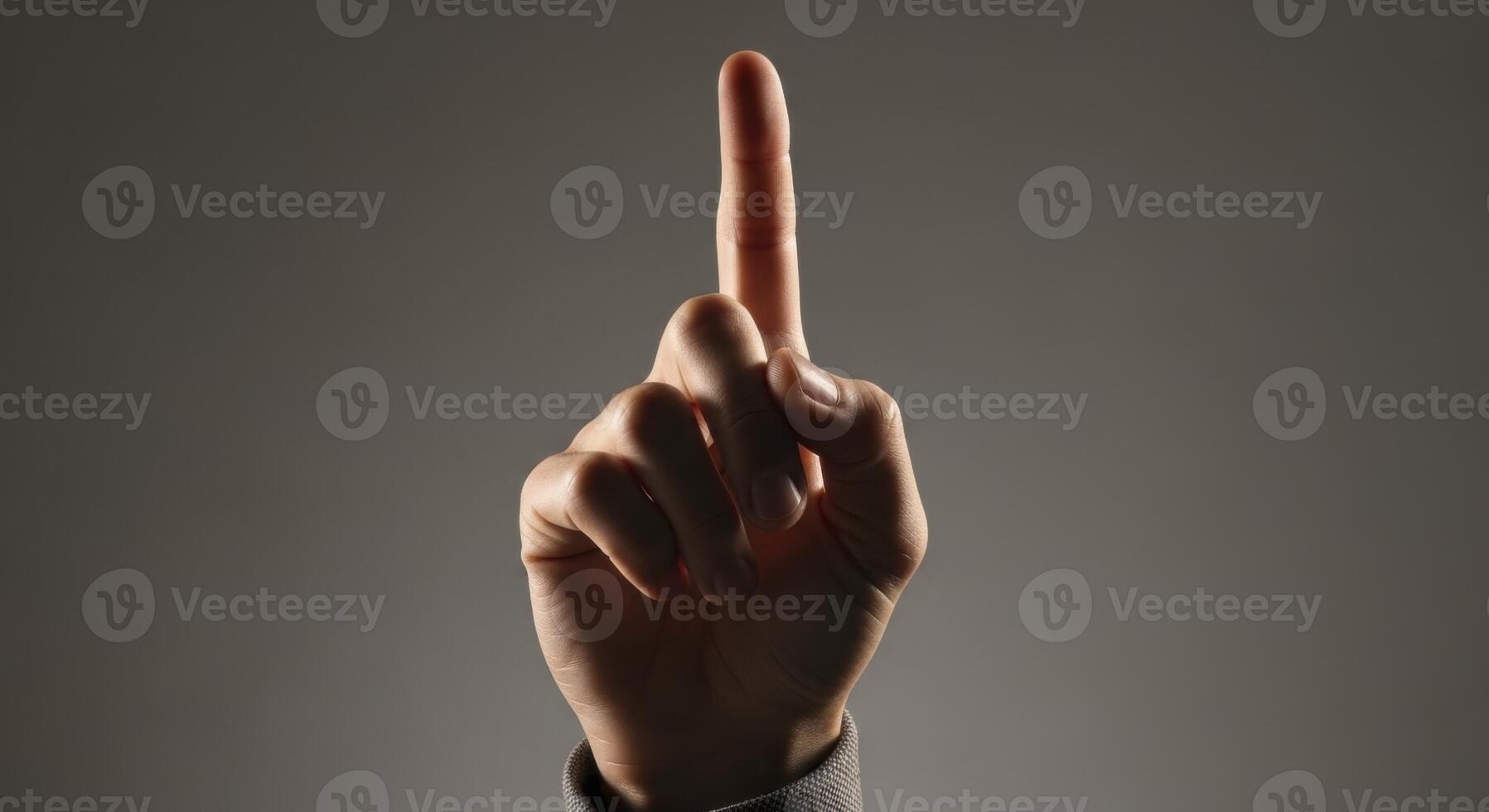 Human Hand with Index Finger Pointing Upwards Representing Direction or Number One photo