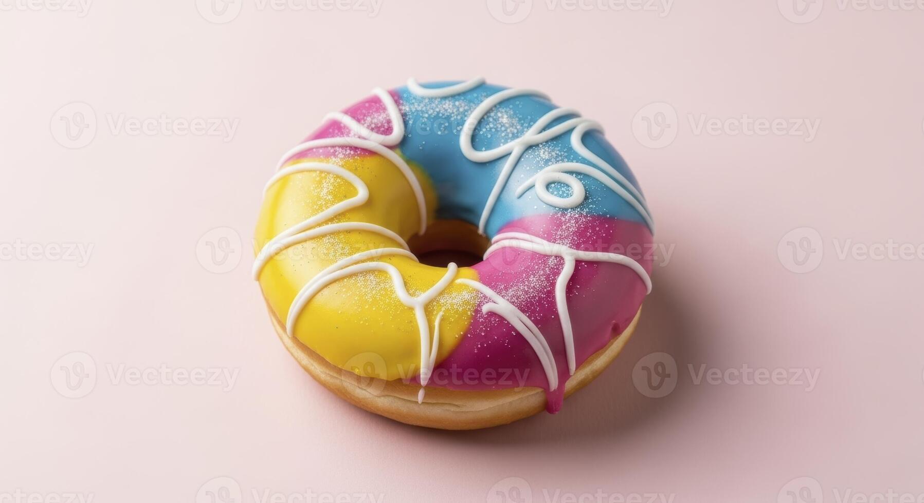 Brightly Colored Donut with Yellow Blue and Pink Icing and White Drizzle photo