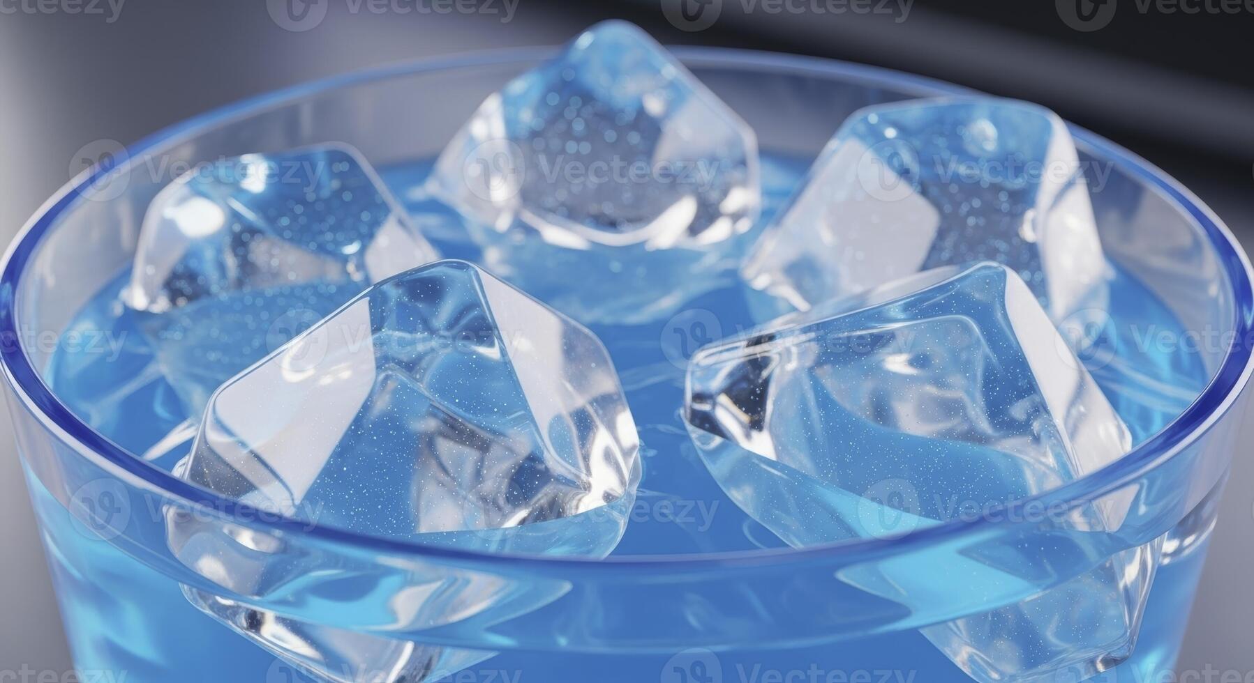 Clear geometric ice cubes floating in a vibrant blue drink inside a glass photo