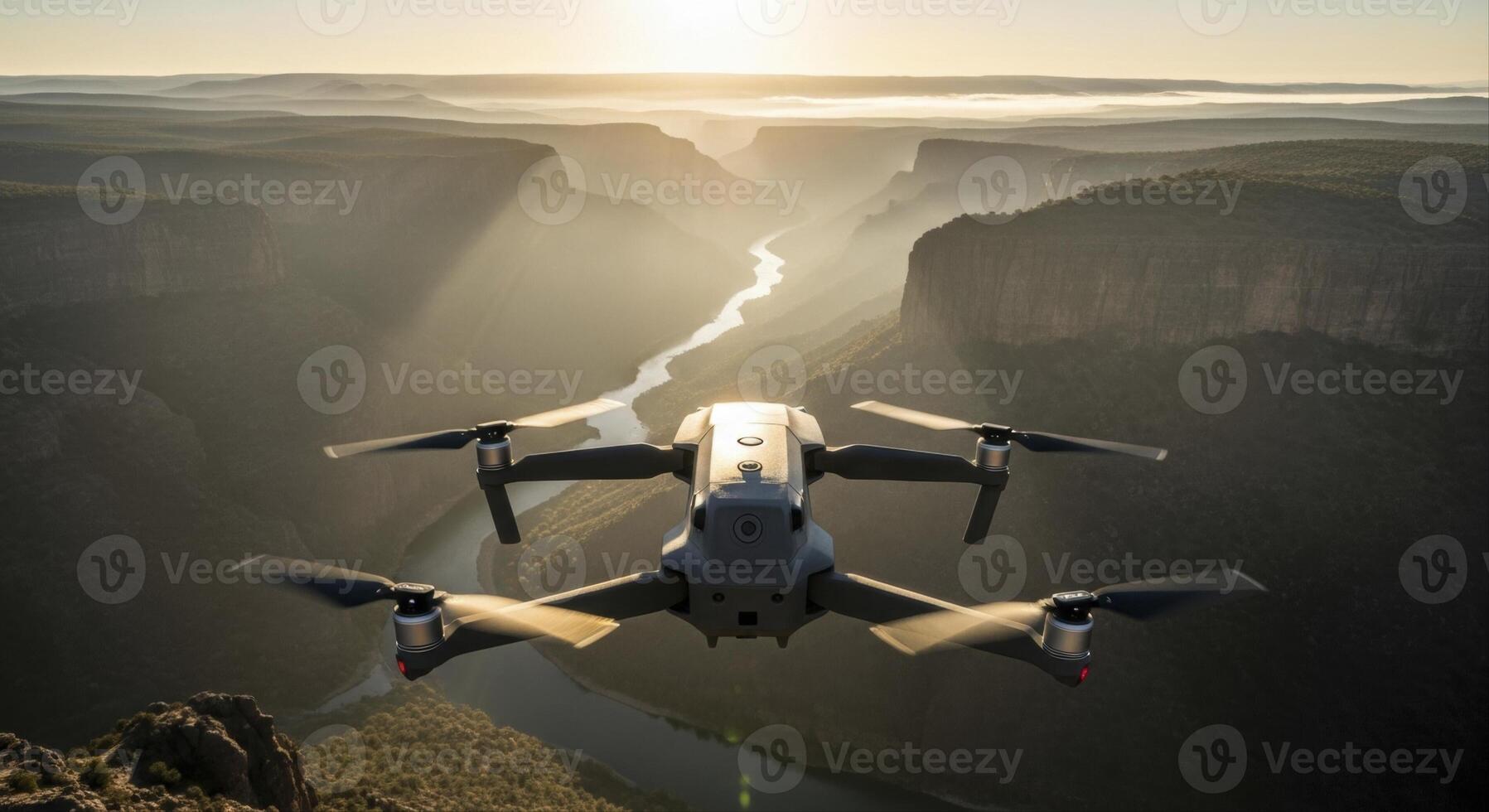 Modern drone capturing an aerial view of a vast canyon and winding river at sunrise photo