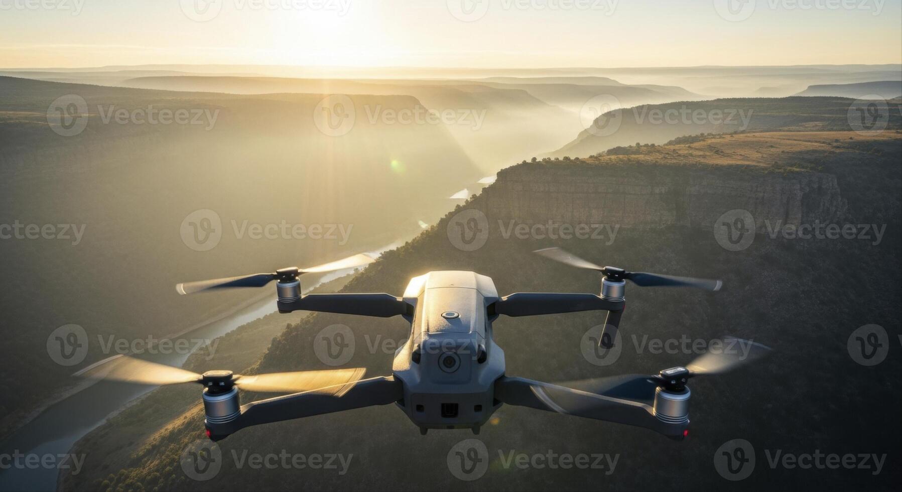 Grey Drone Flying Over a Vast Misty River Valley During Golden Hour photo