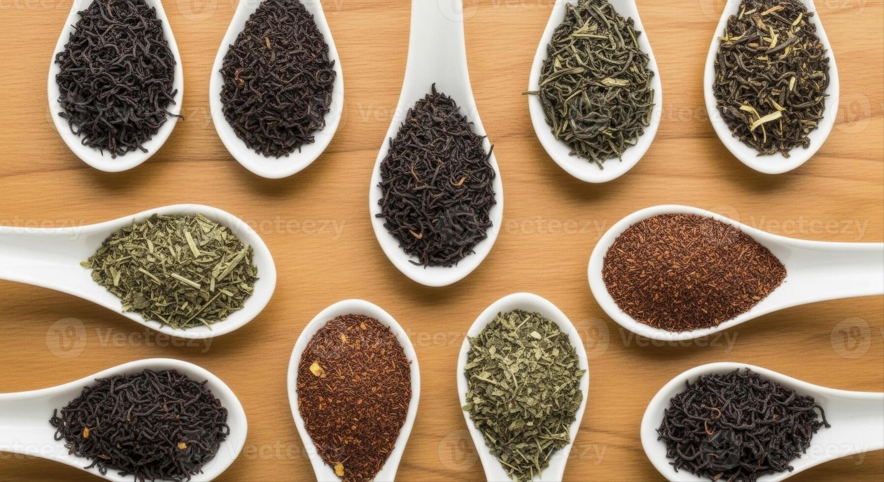 Assortment of dry loose leaf tea varieties in white spoons on a wooden surface photo