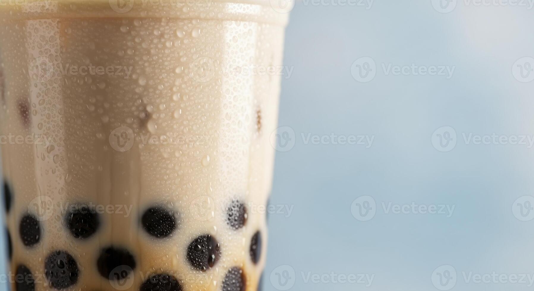 Refreshing Bubble Tea with Tapioca Pearls and Condensation on Plastic Cup photo