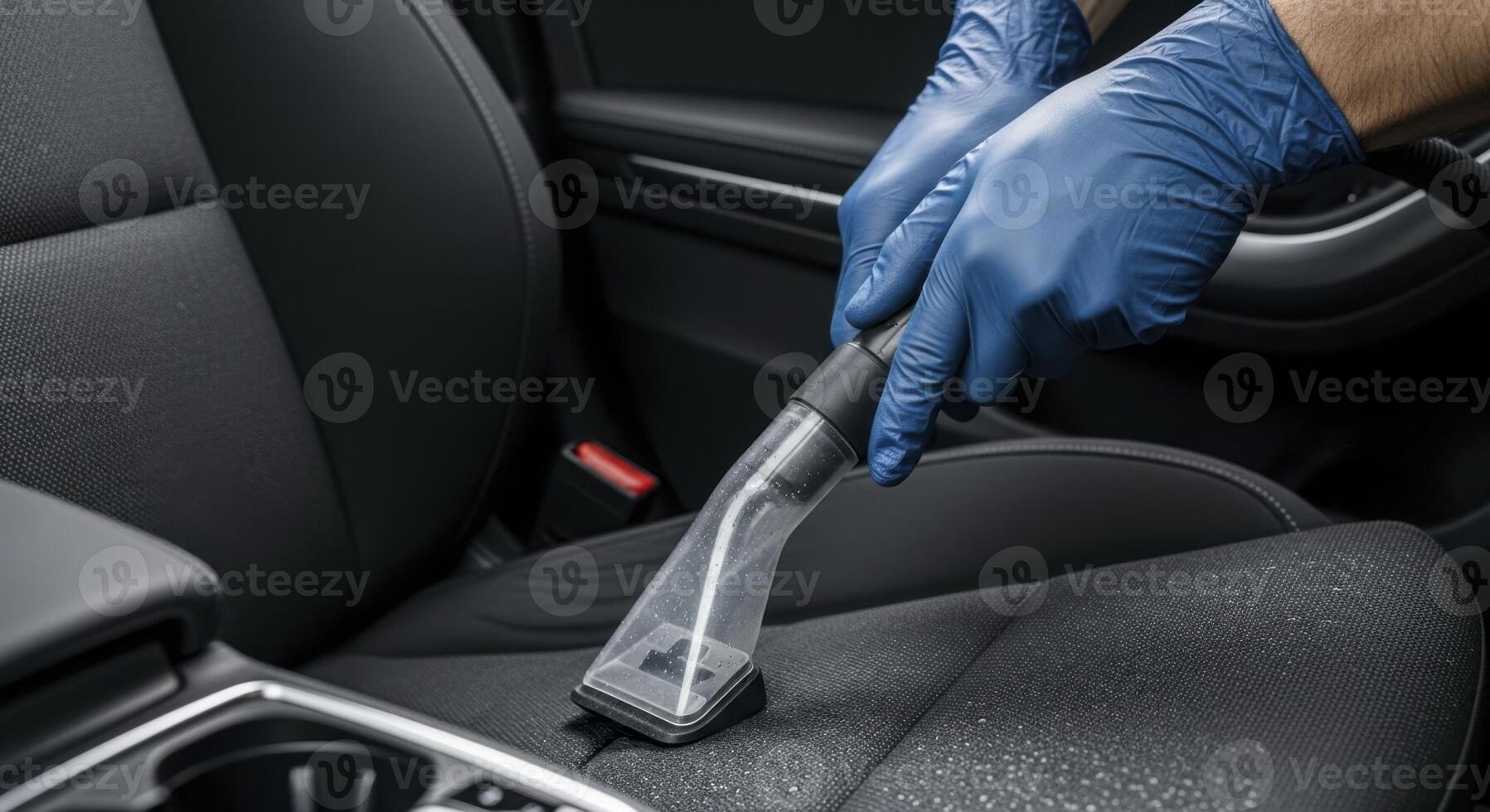 Professional Car Interior Cleaning with Vacuum by Hands in Blue Protective Gloves photo