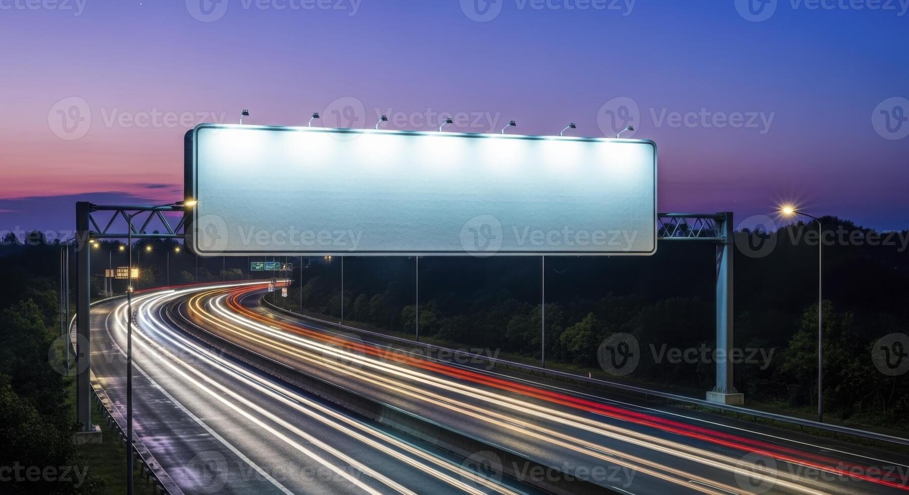Blank Illuminated Billboard Over a Busy Highway with Streaks of Light at Twilight photo