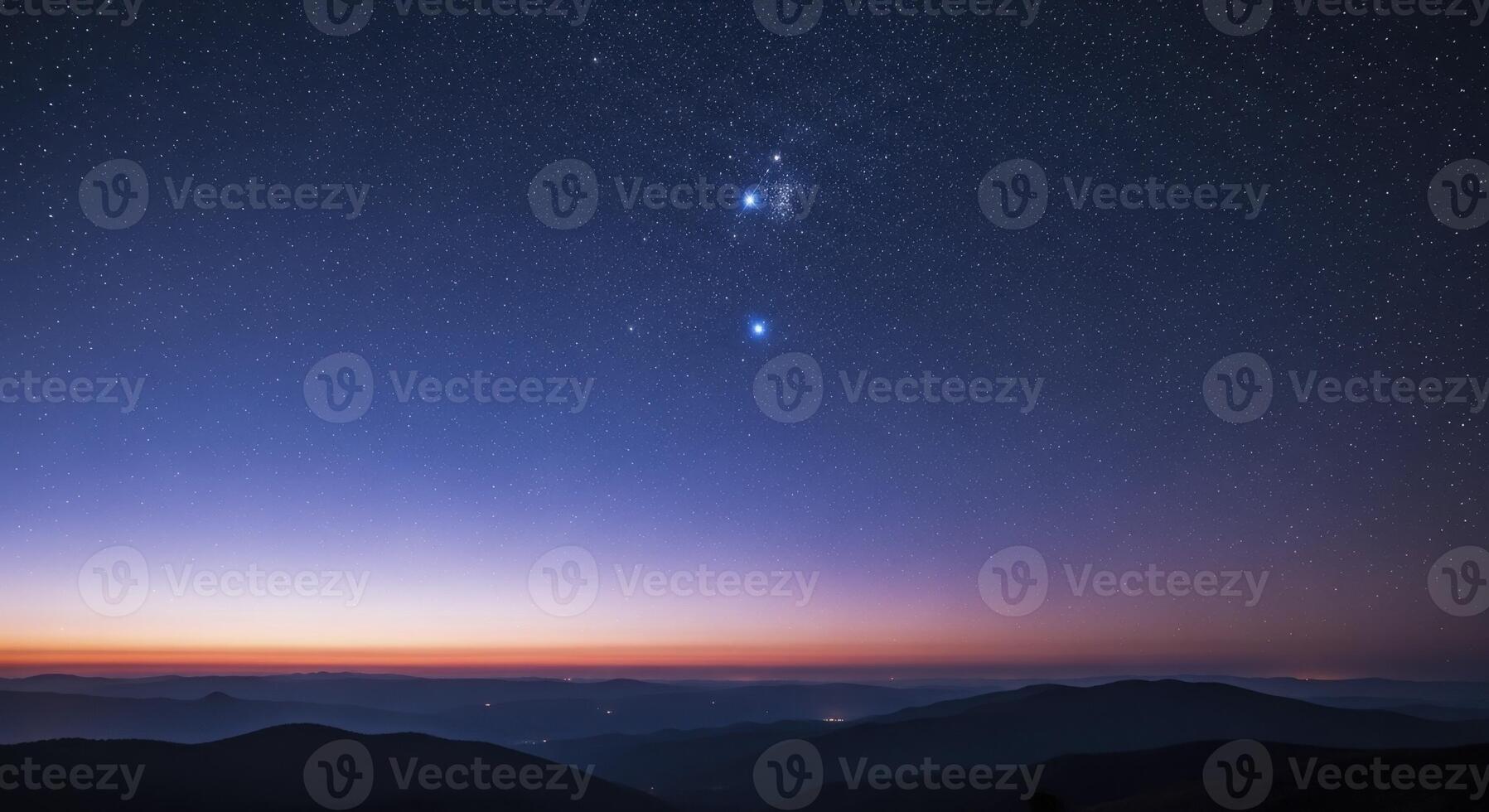 Starry night sky with constellations over mountain silhouettes at twilight photo
