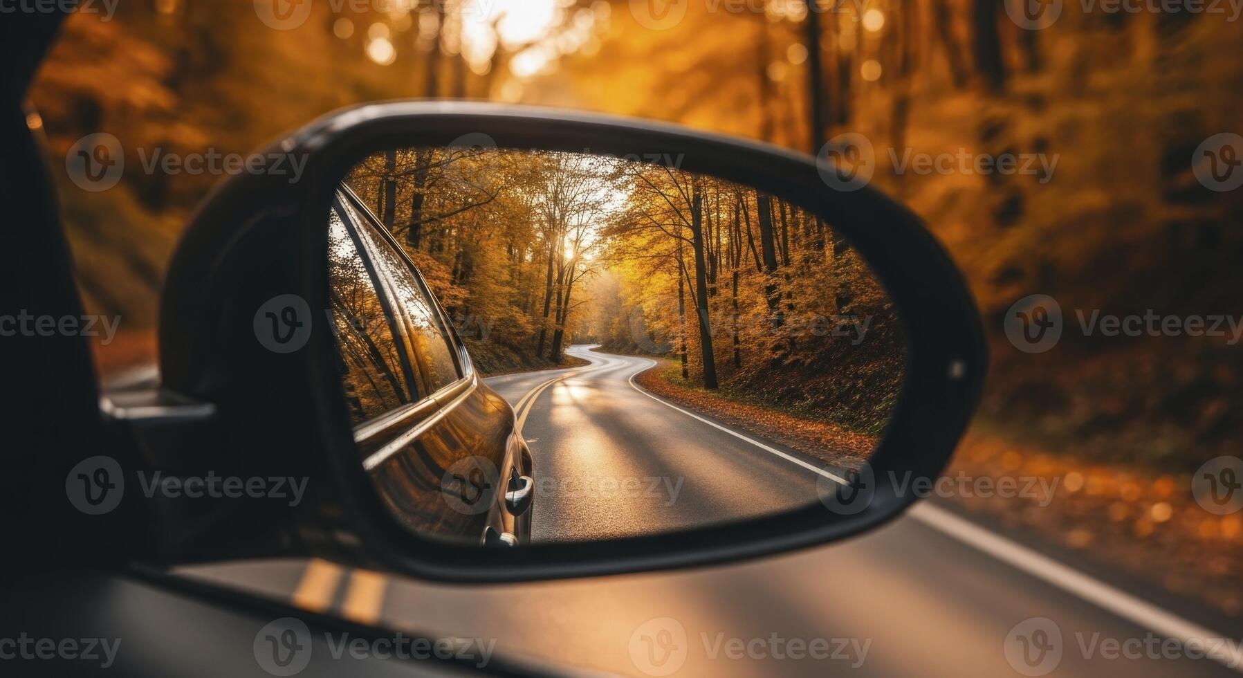 Autumn Road Reflected in Car Side Mirror with Golden Sunlight Through Forest Trees photo