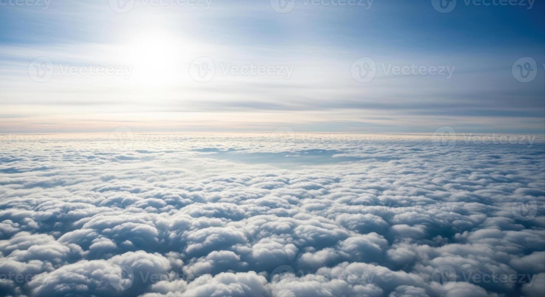 Aerial view of a vast cloudscape stretching to the horizon under a bright blue sky photo
